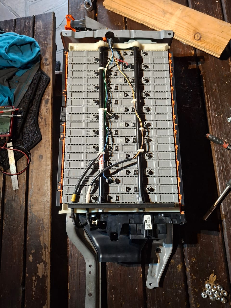 Open EV battery pack showing modules, wiring and service tools during complete battery work. Client-supplied Dieselman Nam image.